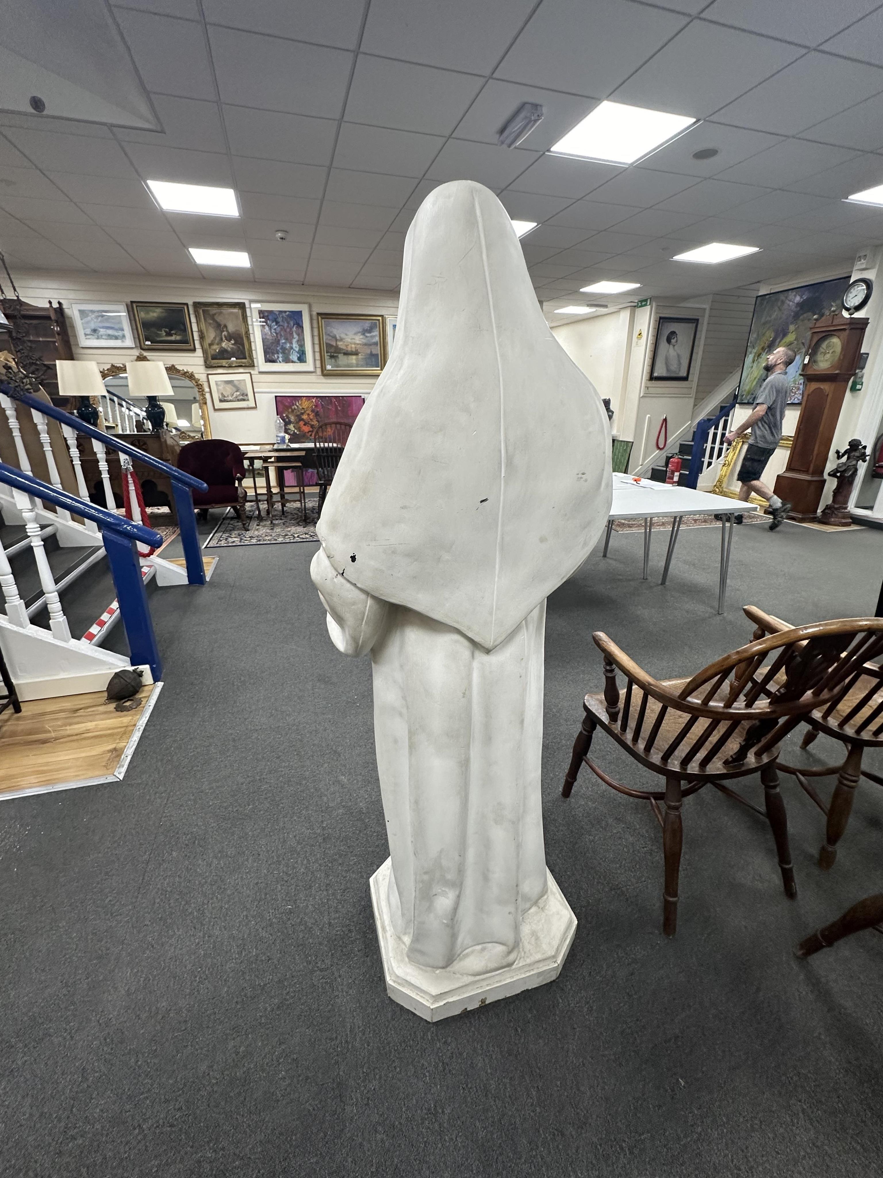 A late 19th/early 20th century life sized figure of a standing nun holding a book, height 158cm. Condition - poor to fair